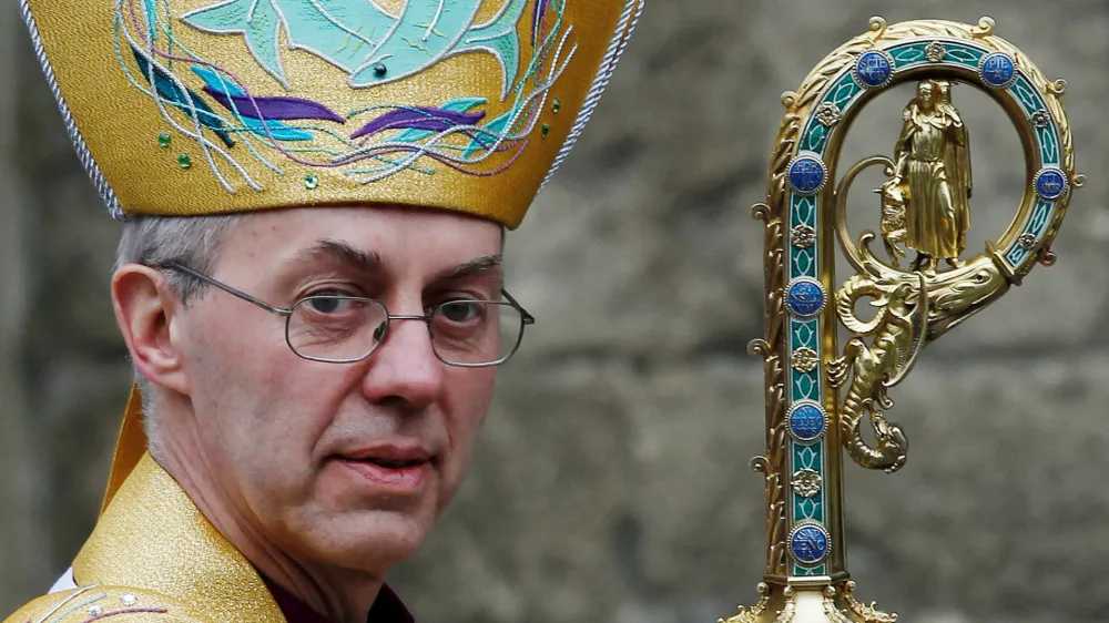 FILE PHOTO: Justin Welby leaves after his enthronement ceremony as Archbishop of Canterbury at Canterbury Cathedral, in Canterbury, southern England March 21, 2013. REUTERS/Luke MacGregor/File Photo