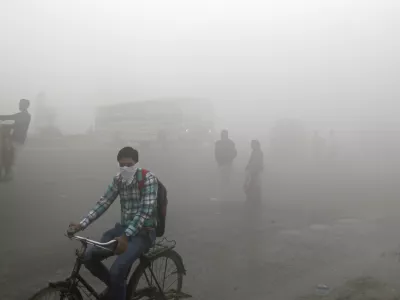 ﻿Indian commuters wait for transport amid thick blanket of smog on the outskirts of New Delhi, India, Friday, Nov. 10, 2017. As air pollution peaked this week in Delhi, it rose to more than 30 times the World Health Organizationâ€™s recommended safe level. Experts have compared it to smoking a couple of packs of cigarettes a day. A recent report by the Lancet medical journal estimated that a quarter of all premature deaths in India, some 2.5 million each year, are caused by pollution. (AP Photo/Altaf Qadri)