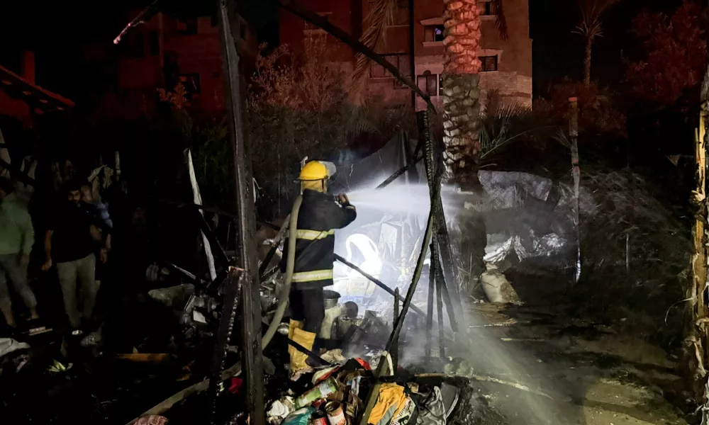 A Palestinian firefighter works to extinguish fire following an Israeli strike on tents of displaced people, in Deir Al-Balah in the central Gaza Strip November 12, 2024. REUTERS/Ahmed Mustafa