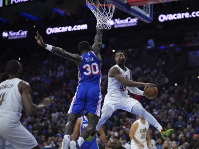 Cleveland Cavaliers' Donovan Mitchell (45) passes against Philadelphia 76ers' Adem Bona (30) during the second half of an NBA basketball game, Wednesday, Nov. 13, 2024, in Philadelphia. (AP Photo/Matt Slocum)