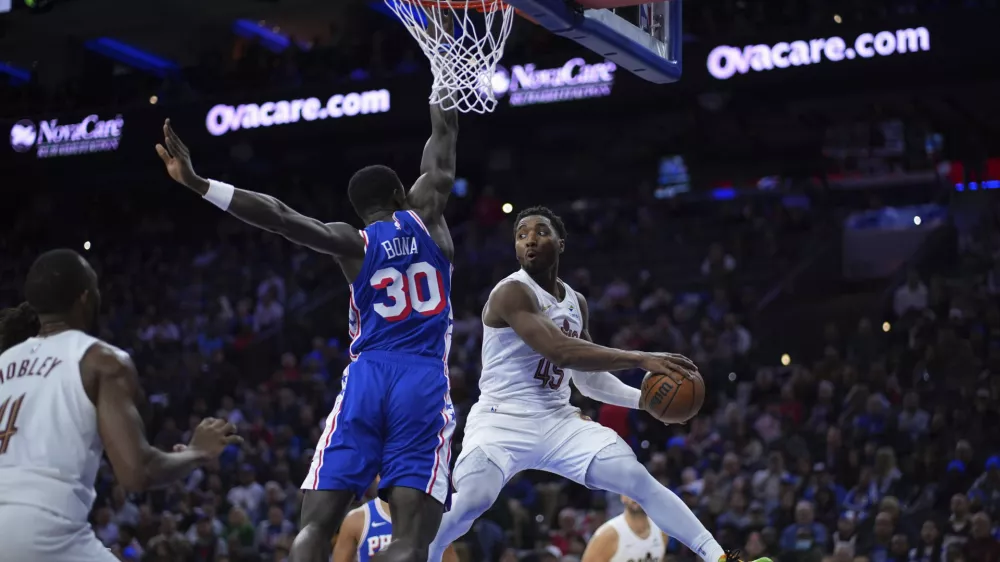 Cleveland Cavaliers' Donovan Mitchell (45) passes against Philadelphia 76ers' Adem Bona (30) during the second half of an NBA basketball game, Wednesday, Nov. 13, 2024, in Philadelphia. (AP Photo/Matt Slocum)