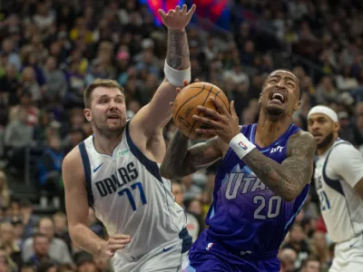 Utah Jazz forward John Collins (20) looks for a shot as Dallas Mavericks guard Luka Doncic (77) defends during the second half of an NBA basketball game Thursday, Nov. 14, 2024, in Salt Lake City. (AP Photo/Rick Egan)