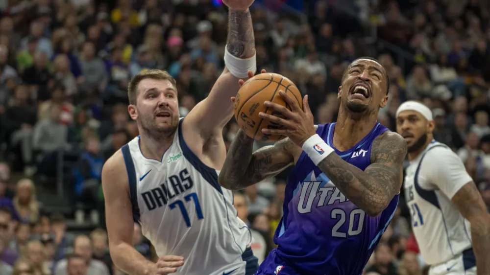 Utah Jazz forward John Collins (20) looks for a shot as Dallas Mavericks guard Luka Doncic (77) defends during the second half of an NBA basketball game Thursday, Nov. 14, 2024, in Salt Lake City. (AP Photo/Rick Egan)