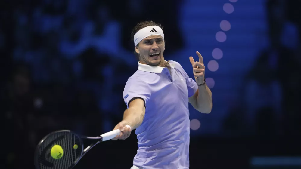 Germany's Alexander Zverev returns the ball to Spain's Carlos Alcaraz during their singles tennis match of the ATP World Tour Finals at the Inalpi Arena, in Turin, Italy, Friday, Nov. 15, 2024. (AP Photo/Antonio Calanni)