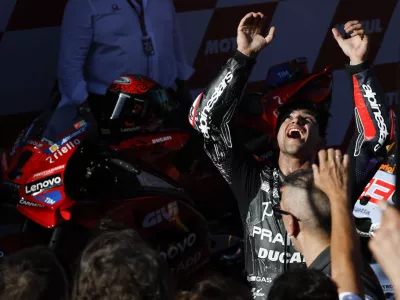 Moto GP World Champion winner Spain's rider Jorge Martin of the Prima Pramac Racing celebrates with team members after finishing third during the MotoGP race of the Grand Prix of Barcelona at the Catalunya racetrack in Montmelo, just outside of Barcelona, Spain, Sunday, Nov. 17, 2024. (AP Photo/Joan Monfort)