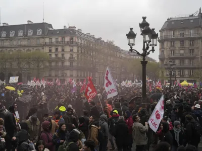 Demonstrators gather outside the Paris town hall, Friday, April 14, 2023 in Paris. France's Constitutional Council on Friday approved an unpopular plan to raise the retirement age to 64, in a victory for French President Emmanuel Macron after three months of mass protests over the legislation that have damaged his leadership. The move is likely to enrage unions and other opponents of the pension plan, including protesters gathered in spots around France on Friday evening as the decision came down.(AP Photo/Lewis Joly)