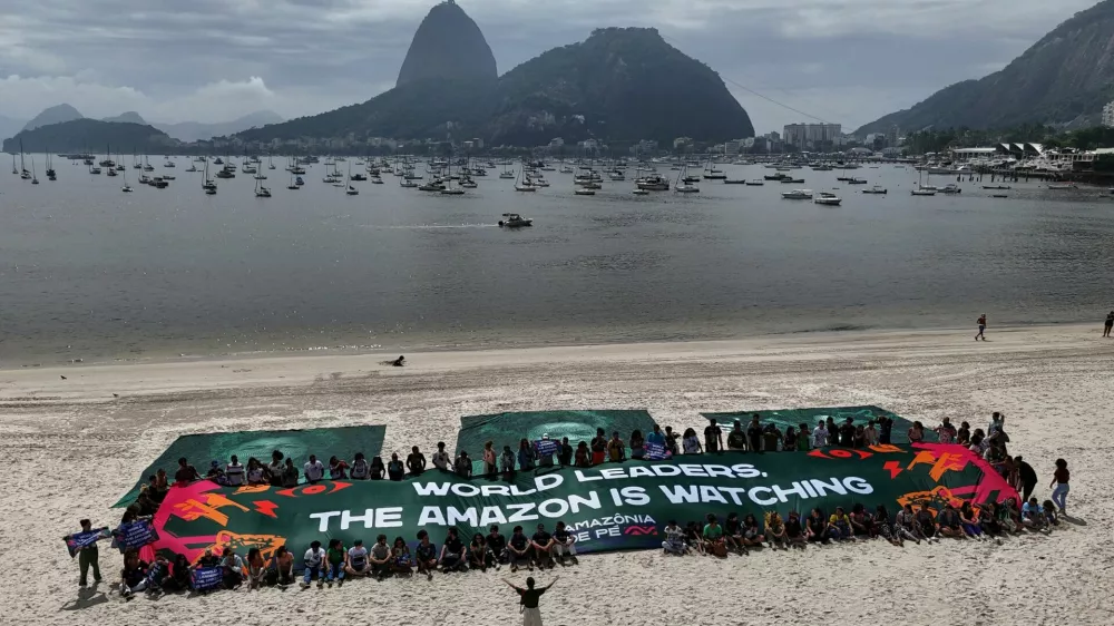 A drone view shows banners with the faces of activist Angela Mendes, daughter of late environmentalist Chico Mendes, Quilombo's leader Kelly Araujo and indigenous leader Txai Surui, ahead of the G20 Summit in Praia de Botafogo beach in Rio de Janeiro, Brazil November 17, 2024. REUTERS/Pilar Olivares