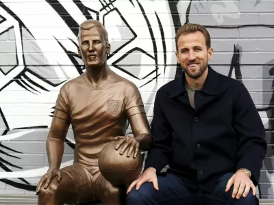 Harry Kane poses during the unveiling of a statue of himself at The Peter May Centre in London, Monday Nov. 18, 2024. (Zac Goodwin/PA via AP)