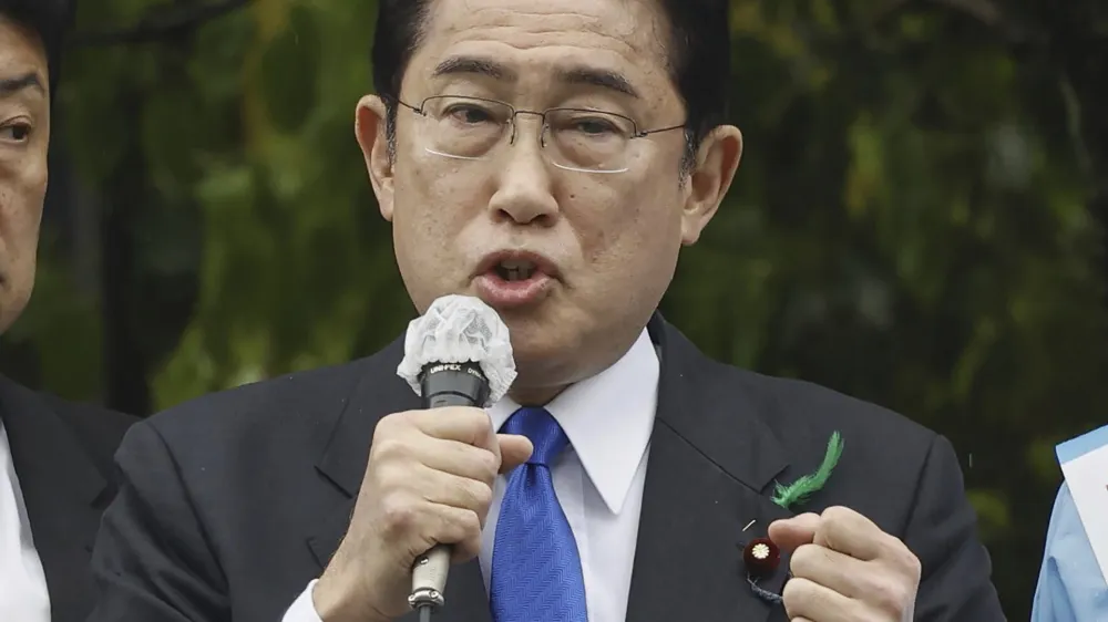 Japanese Prime Minister Fumio Kishida delivers a speech to support his ruling party's candidate in a local election, near a train station in Wakayama, western Japan Saturday, April 15, 2023. Kishida was evacuated unharmed after an explosion at a western port on Saturday, NHK television reported, and a suspect was apprehended for allegedly throwing the explosive. (Kyodo News via AP)