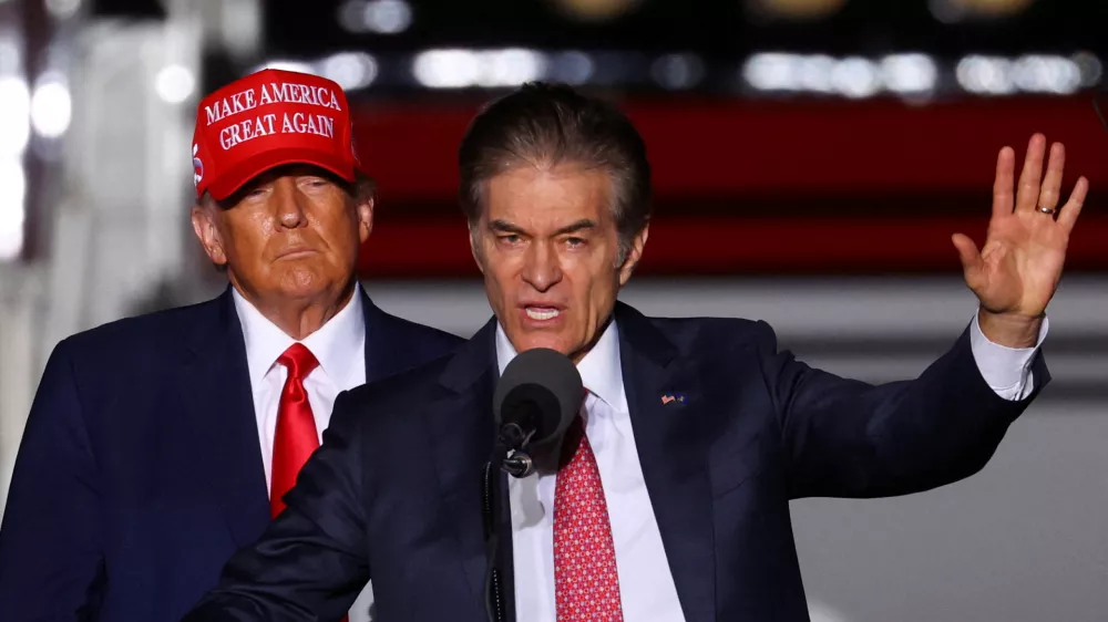 FILE PHOTO: Former U.S. President Donald Trump looks on as Pennsylvania Republican U.S. Senate candidate Dr. Mehmet Oz speaks at a pre-election rally to support Republican candidates in Latrobe, Pennsylvania, U.S., November 5, 2022. REUTERS/Mike Segar/File Photo