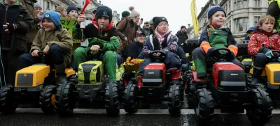 Children sit in toy tractors, as farmers protest against the Labour government's new agricultural policy, which includes a budget measure expected to increase inheritance tax liabilities for some farmers, in London, Britain, November 19, 2024. REUTERS/Mina Kim