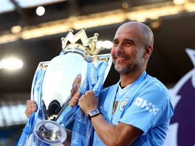 FILE PHOTO: Soccer Football - Premier League - Manchester City v West Ham United - Etihad Stadium, Manchester, Britain - May 19, 2024 Manchester City manager Pep Guardiola celebrates with the trophy after winning the Premier League Action Images via Reuters/Lee Smith EDITORIAL USE ONLY. NO USE WITH UNAUTHORIZED AUDIO, VIDEO, DATA, FIXTURE LISTS, CLUB/LEAGUE LOGOS OR 'LIVE' SERVICES. ONLINE IN-MATCH USE LIMITED TO 120 IMAGES, NO VIDEO EMULATION. NO USE IN BETTING, GAMES OR SINGLE CLUB/LEAGUE/PLAYER PUBLICATIONS. PLEASE CONTACT YOUR ACCOUNT REPRESENTATIVE FOR FURTHER DETAILS../File Photo