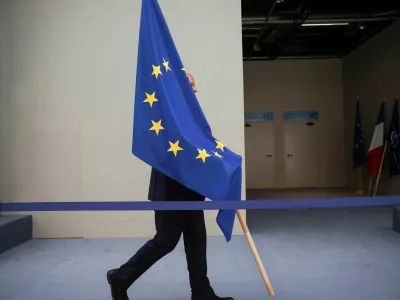 A person carries the EU flag during a NATO leaders summit in Vilnius, Lithuania July 12, 2023. REUTERS/Kacper Pempel