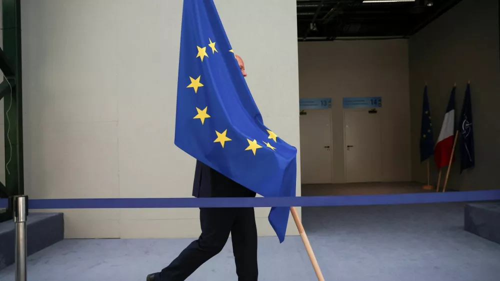 A person carries the EU flag during a NATO leaders summit in Vilnius, Lithuania July 12, 2023. REUTERS/Kacper Pempel