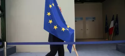 A person carries the EU flag during a NATO leaders summit in Vilnius, Lithuania July 12, 2023. REUTERS/Kacper Pempel