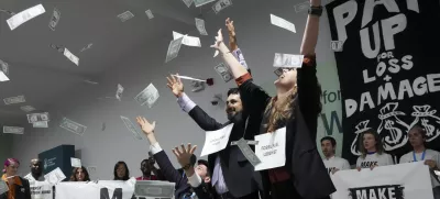 Activists participate in a demonstration for climate finance at the COP29 U.N. Climate Summit, Thursday, Nov. 21, 2024, in Baku, Azerbaijan. (AP Photo/Sergei Grits)