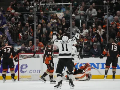 Los Angeles Kings center Anze Kopitar (11) celebrates after right wing Adrian Kempe (9) scored during the third period of an NHL hockey game against the Anaheim Ducks in Anaheim, Calif., Thursday, April 13, 2023. (AP Photo/Ashley Landis)