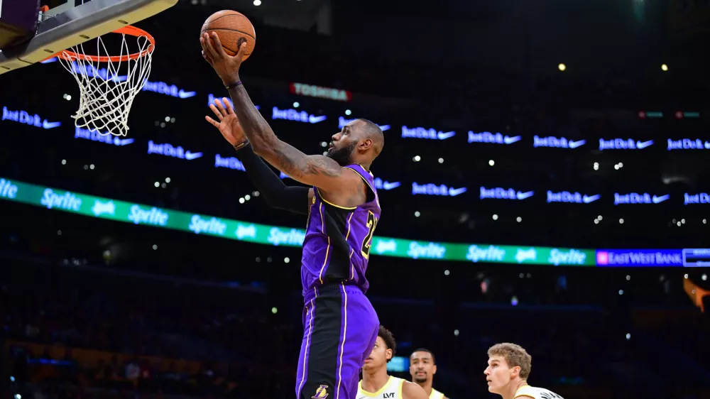 Nov 19, 2024; Los Angeles, California, USA; Los Angeles Lakers forward LeBron James (23) scores a basket against the against the Utah Jazz during the first half at Crypto.com Arena. Mandatory Credit: Gary A. Vasquez-Imagn Images