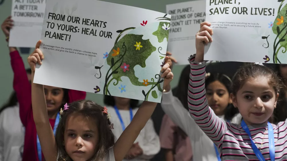 Children advocate for a clean planet during the COP29 U.N. Climate Summit, Thursday, Nov. 21, 2024, in Baku, Azerbaijan. (AP Photo/Peter Dejong)