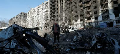 FILE PHOTO: Local resident and mechanic Vadim Tarasenko, 56, stands next to the wreckage of his car in the courtyard of an apartment building destroyed in the course of Ukraine-Russia conflict in the besieged southern port city of Mariupol, Ukraine March 28, 2022. REUTERS/Alexander Ermochenko/File Photo