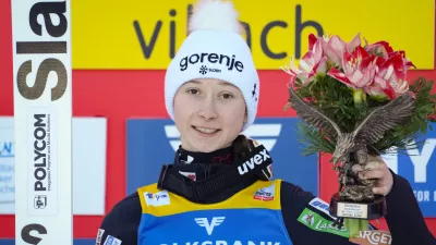 Gold medal winner Slovenia's Nika Prevc poses on the podium at the Women Normal Hill Individual Ski Jumping World Cup event in Villach, Austria, Thursday, Jan. 4, 2024. (AP Photo/Darko Bandic)