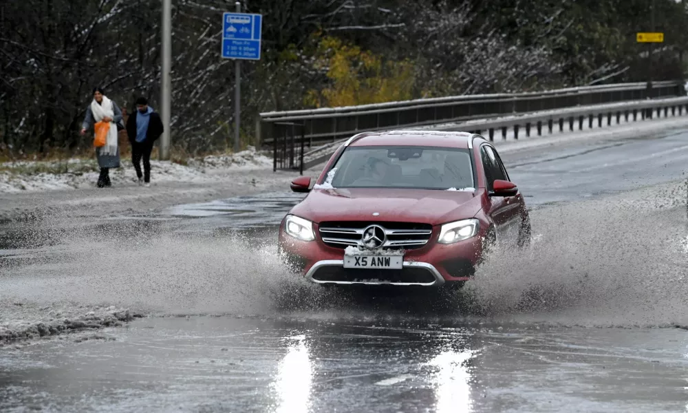 A car drives through water along the A90, as a result of Storm Bert, in Cramond near Edinburgh, Scotland, Britain, November 23, 2024. REUTERS/Lesley Martin