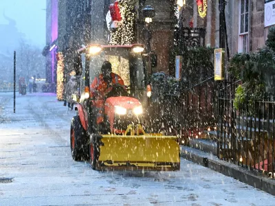 A snow plough clears the snow during Storm Bert, along George Street in Edinburgh, Scotland, Britain, November 23, 2024. REUTERS/Lesley Martin