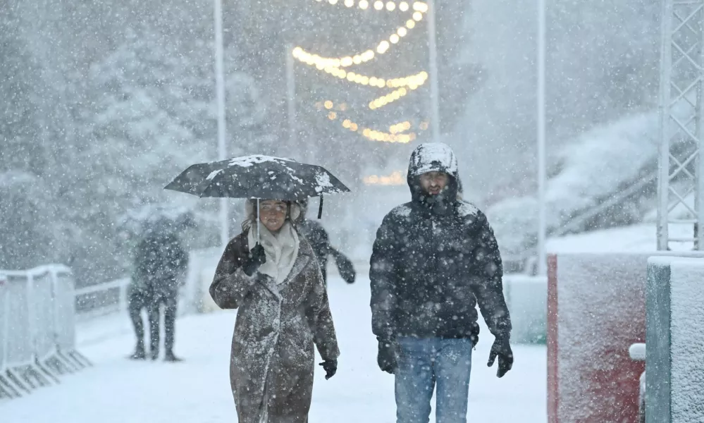 People walk through the snowfall during Storm Bert, along Princes Street Gardens in Edinburgh, Scotland, Britain, November 23, 2024. REUTERS/Lesley Martin