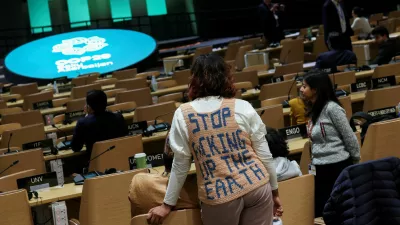 An activist stands during a closing plenary meeting at the COP29 United Nations Climate Change Conference, in Baku, Azerbaijan November 24, 2024. REUTERS/Murad Sezer   TPX IMAGES OF THE DAY