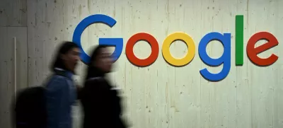 FILE PHOTO: People walk next to a Google logo during a trade fair in Hannover Messe, in Hanover, Germany, April 22, 2024. REUTERS/Annegret Hilse/File Photo