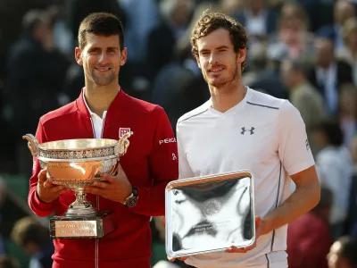 FILE - Serbia's Novak Djokovic, left, and Britain's Andy Murray holds their trophy after their final match of the French Open tennis tournament at the Roland Garros stadium, Sunday, June 5, 2016 in Paris.  (AP Photo/Alastair Grant, File)