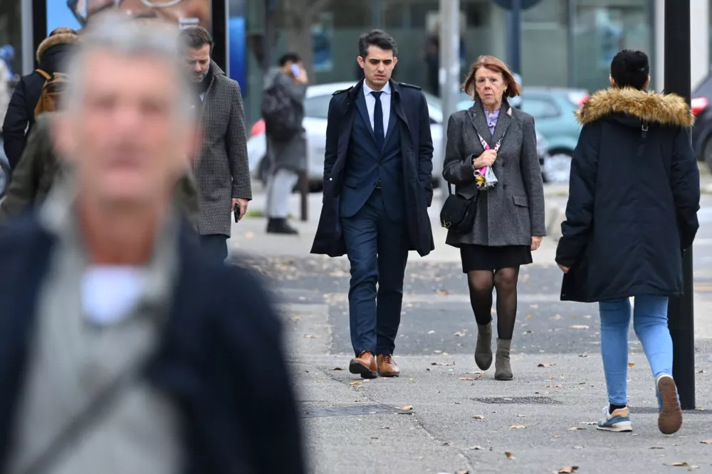 Frenchwoman Gisele Pelicot, the victim of an alleged mass rape orchestrated by her husband Dominique Pelicot at their home in the southern French town of Mazan, arrives with her lawyers Stephane Babonneau and Antoine Camus in court as prosecutors say what sentences they are seeking in the trial for Dominique Pelicot and 50 co-accused, at the courthouse in Avignon, France, November 25, 2024. REUTERS/Alexandre Dimou