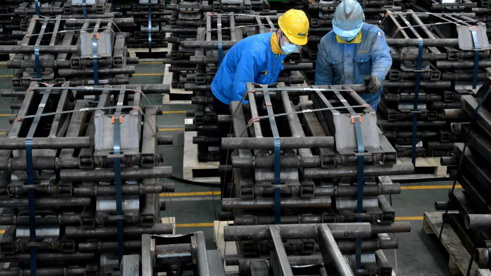 FILE PHOTO: Workers wearing face masks are seen on a production line manufacturing parts for trailers to be exported to the U.S. at a factory, as the country is hit by an outbreak of the novel coronavirus disease (COVID-19), in Taizhou, Jiangsu province, China March 28, 2020. Picture taken March 28, 2020. China Daily via REUTERS ATTENTION EDITORS - THIS IMAGE WAS PROVIDED BY A THIRD PARTY. CHINA OUT./File Photo