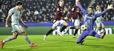 Atletico's Julian Alvarez, left, scores his side's second goal against Sparta's goalkeeper Peter Vindahl during the UEFA Champions League opening phase soccer match between Sparta Prague and Athletico Madrid in Prague, Czech Republic, Tuesday, Nov. 26, 2024. (Roman Vondrous//CTK via AP)