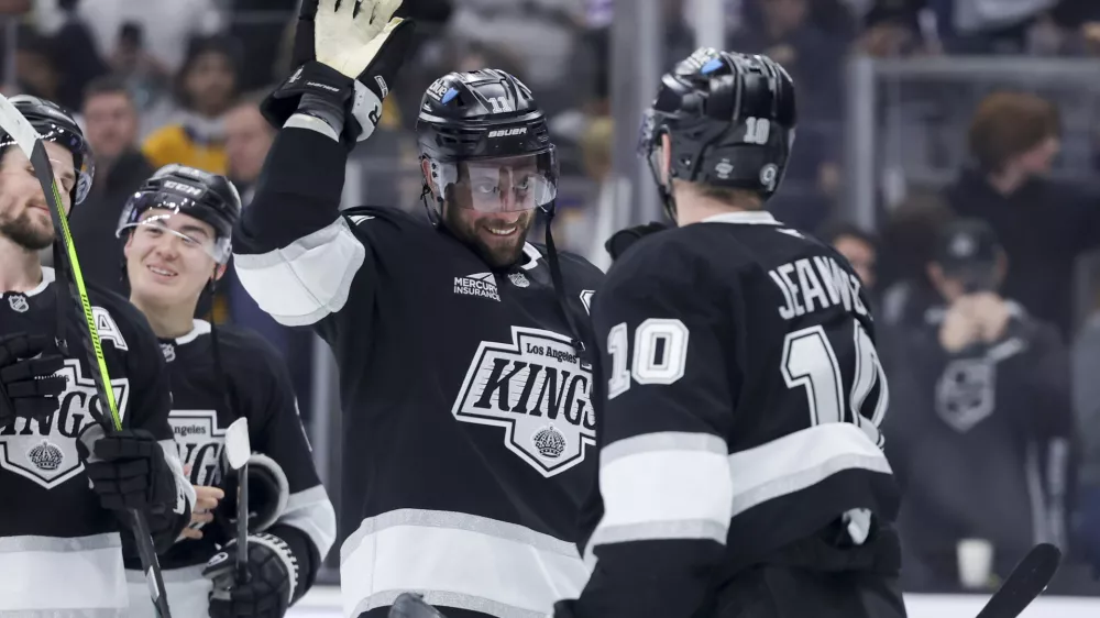 Los Angeles Kings center Anze Kopitar, left, celebrates with left wing Tanner Jeannot after the team's win against the Winnipeg Jets in an NHL hockey game Wednesday, Nov. 27, 2024, in Los Angeles. (AP Photo/Ryan Sun)