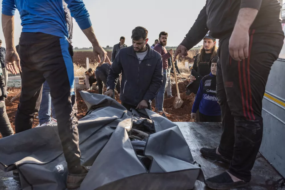 28 November 2024, Syria, Atarib: A man looks at the body of a relative who was killed in a Syrian regime airstrike that targeted the city of Atarib in the Aleppo countryside Photo: Anas Alkharboutli/dpa