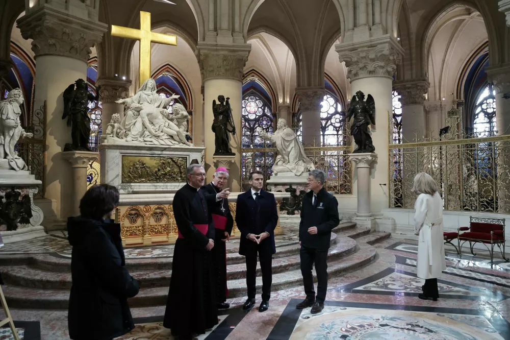 French President Emmanuel Macron during a visit to Notre-Dame de Paris cathedral in Paris, France, 29 November 2024. French President Macron is visiting the cathedral's construction site on 29 November, to thank the donors and people who worked to rebuild the monument after it was severely damaged in a fire that broke out on 15 April 2019. The Paris Cathedral will be officially inaugurated after nearly six years of renovation work on 07 December 2024. CHRISTOPHE PETIT TESSON/Pool via REUTERS