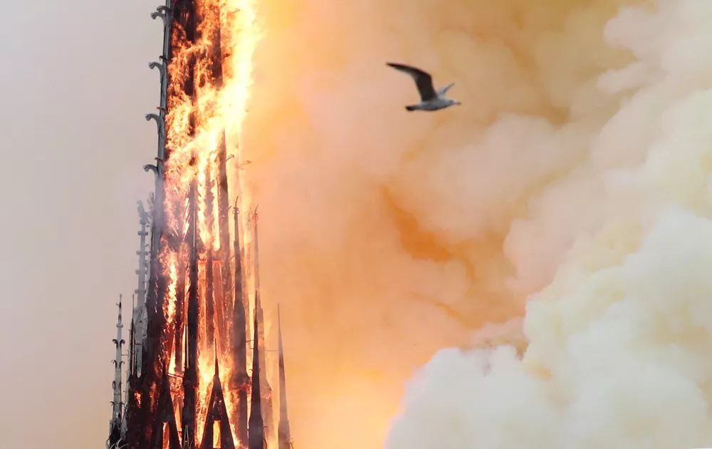 FILE PHOTO: Smoke billows as fire engulfs the spire of Notre Dame Cathedral in Paris, France April 15, 2019. REUTERS/Benoit Tessier/File Photo