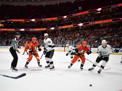 Nov 29, 2024; Anaheim, California, USA; Anaheim Ducks right wing Frank Vatrano (77) plays for the puck against Los Angeles Kings defenseman Jacob Moverare (43) during the second period at Honda Center. Mandatory Credit: Gary A. Vasquez-Imagn Images