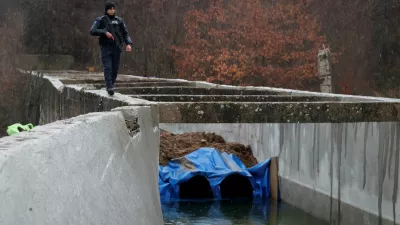 A police officer patrols near the damaged canal in northern Kosovo supplying water to two coal-fired power plants that generate nearly all of the country's electricity, in Varage, near Zubin Potok, Kosovo November 30, 2024. REUTERS/Valdrin Xhemaj