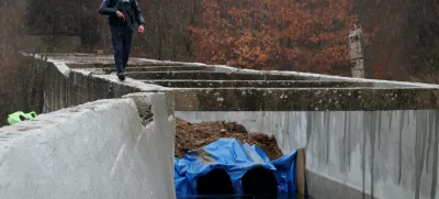 A police officer patrols near the damaged canal in northern Kosovo supplying water to two coal-fired power plants that generate nearly all of the country's electricity, in Varage, near Zubin Potok, Kosovo November 30, 2024. REUTERS/Valdrin Xhemaj