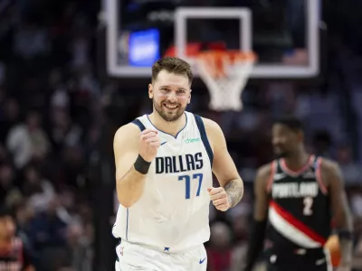 Dallas Mavericks guard Luka Doncic reacts to his teammate's made shot against the Portland Trail Blazers during the second half of an NBA basketball game Sunday, Dec. 1, 2024, in Portland, Ore. (AP Photo/Howard Lao)