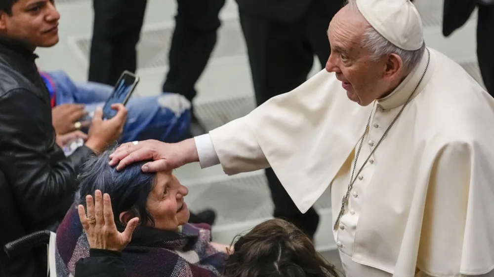 Pope Francis greets faithful at the end of his weekly general audience in the Paul VI Hall, at the Vatican, Wednesday, April 6, 2022. (AP Photo/Alessandra Tarantino)