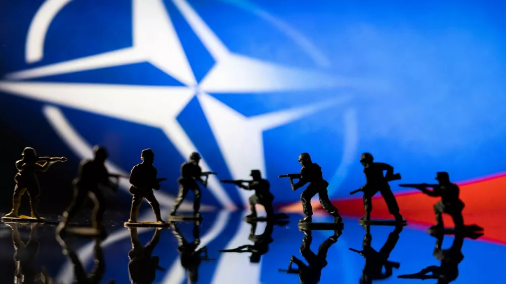 FILE PHOTO: Army soldier figurines are displayed in front of the NATO logo and Russian flag colours background in this illustration taken, February 13, 2022. REUTERS/Dado Ruvic/Illustration/File Photo