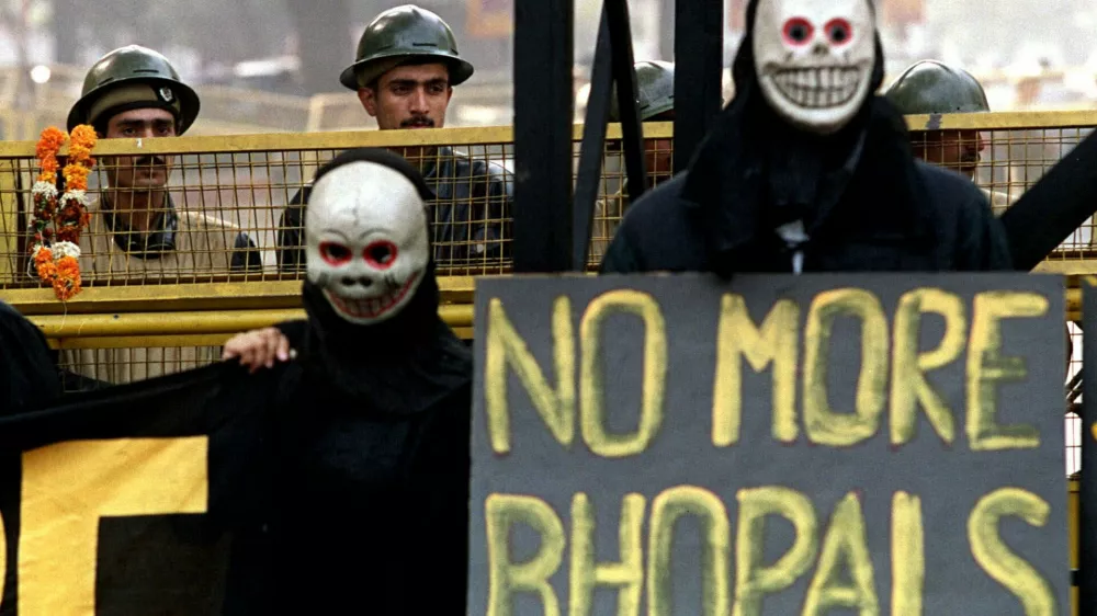 Activists from Greenpeace stage a protest in front of parliament in New Delhi Friday December 3, 1999 on the 15th anniversary of the Union Carbide disaster in Bhopal which killed close to 7,000 people. Greenpeace claims that Union Carbide left behind toxic wastes at the site of the disaster and that few steps are being taken globally to keep incidents like Bhopal from happening again. Activists claim that toxic wastes from the Union Carbide accident have leaked into the groundwater supply in Bhopal, leaving behind a dangerous legacy 15 years after the event. (AP Photo/John McConnico)