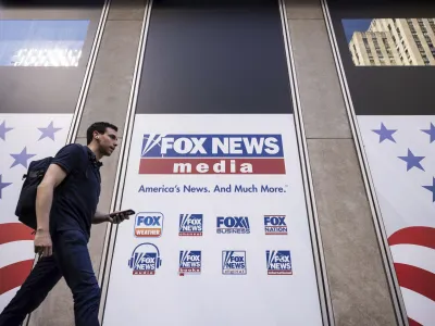 FILE - A person walks past the Fox News Headquarters in New York, Wednesday, April. 12, 2023. Dominion Voting Systems' defamation lawsuit against Fox News for airing bogus allegations of fraud in the 2020 election is set to begin trial on Tuesday, April 18, 2023, in Delaware. (AP Photo/Yuki Iwamura, File)