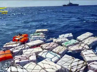 Boxes containing cocaine float in the Sicilian Strait off Catania in this picture made available by the Italian Financial Police on Monday, April 17, 2023. Some two thousand kilograms of cocaine, left afloat in open waters with a tracking device attached, were sized by the Italian Financial Police on Monday. (Italian Financial Police via AP)