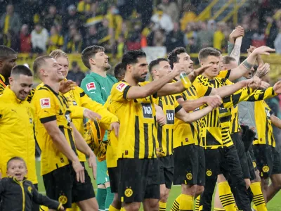 Dortmund players celebrates after defeating Eintracht Frankfurt during the German Bundesliga soccer match between Borussia Dortmund and Eintracht Frankfurt in Dortmund, Germany, Saturday, April 22, 2023. (AP Photo/Martin Meissner)