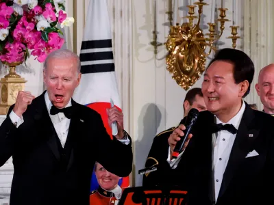 U.S. President Joe Biden reacts as South Korea's President Yoon Suk Yeol sings at an official State Dinner, during Yoon Suk Yeol's visit, at the White House in Washington, U.S. April 26, 2023. REUTERS/Evelyn Hockstein