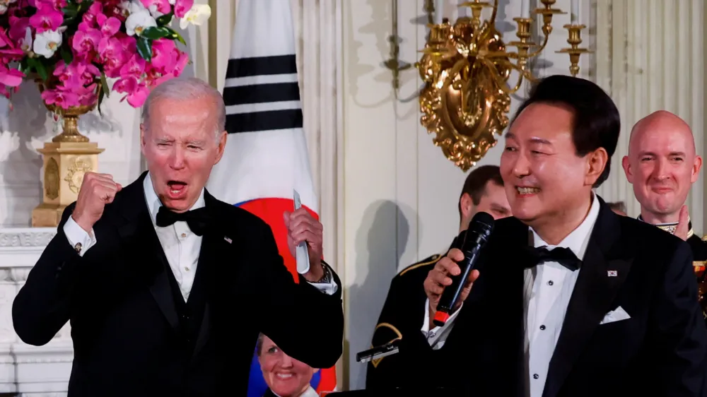 U.S. President Joe Biden reacts as South Korea's President Yoon Suk Yeol sings at an official State Dinner, during Yoon Suk Yeol's visit, at the White House in Washington, U.S. April 26, 2023. REUTERS/Evelyn Hockstein